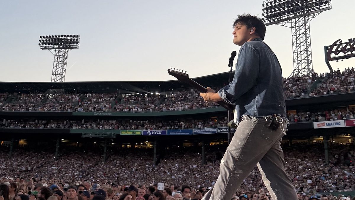 Noah Levine playing his John Page Signature DL Baritone onstage at Fenway Park with Noah Kahan